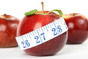 Apple with measuring tape on it.